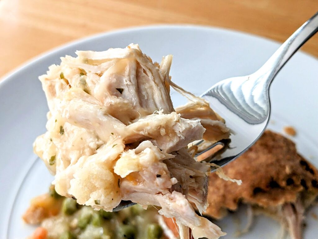 A huge chunk of rotisserie chicken from the inside of a Costco Chicken Pot Pie.