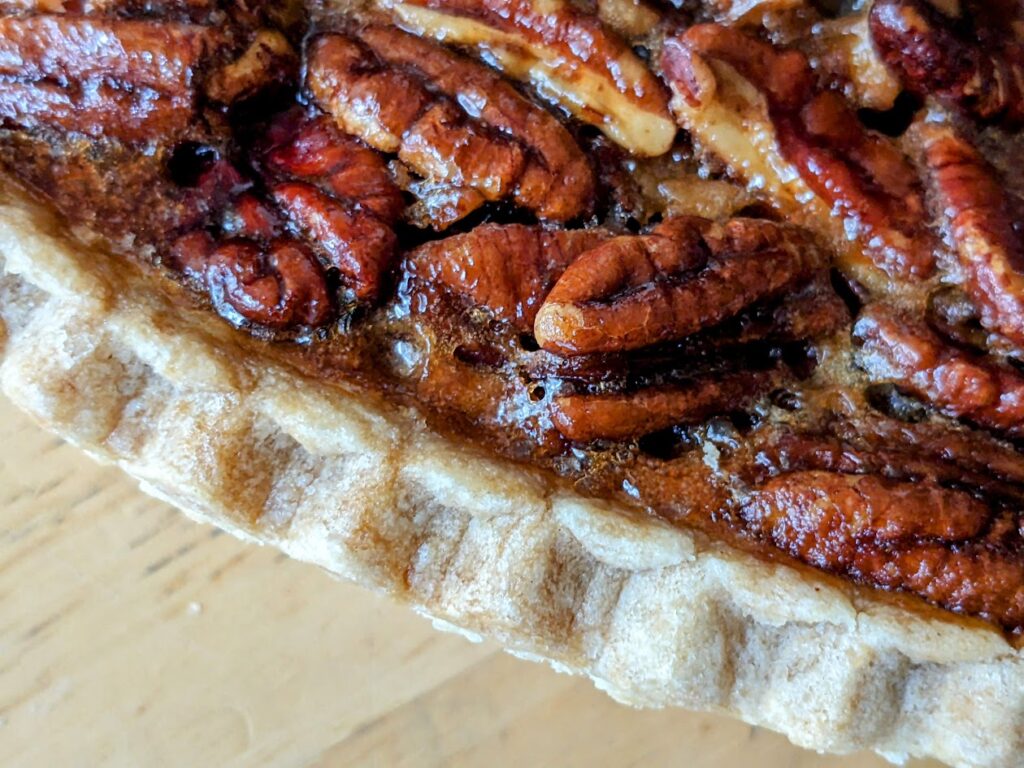 Detail of the crimped pie crust on a Costco Pecan Pie from Kirkland store brand.