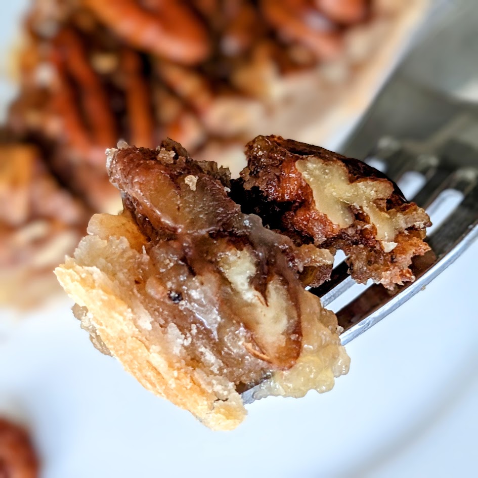 A fork with a bite of pecan pie from the Costco bakery.