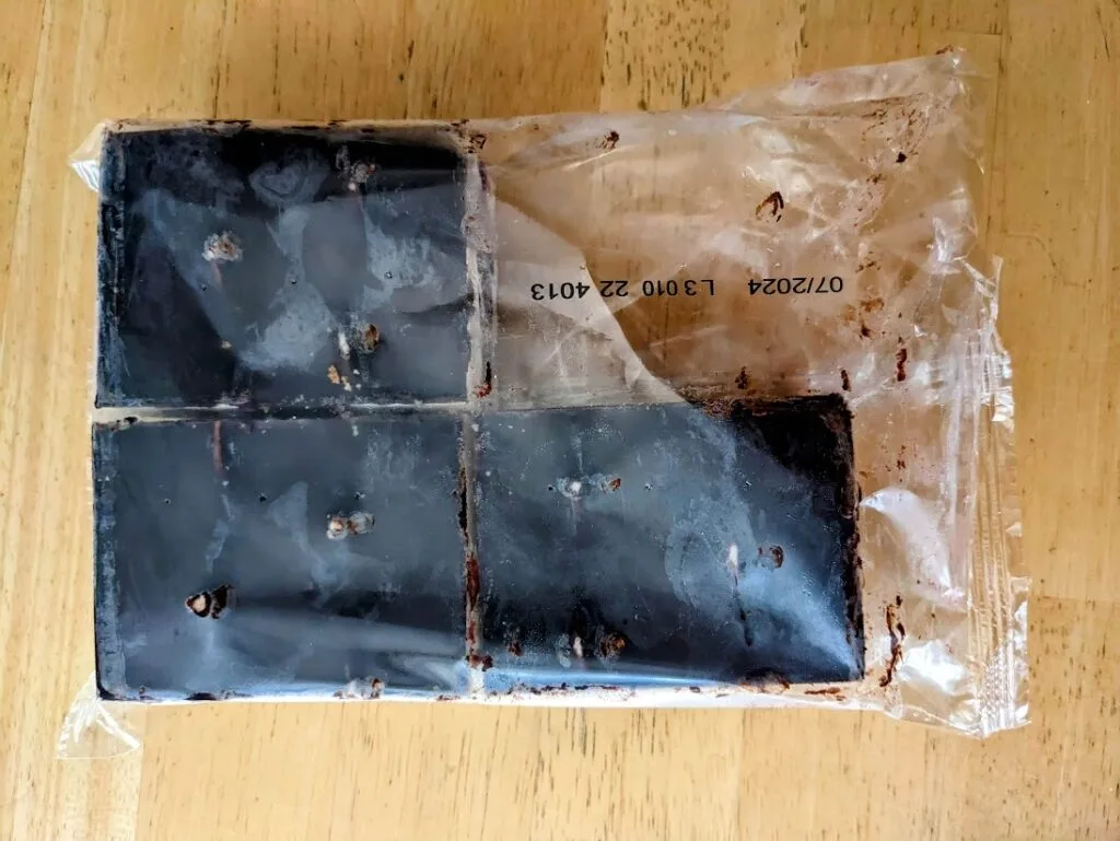 A cellophane bag with three slices of frozen Aldi Donauwelle cake from Deutsche Kuche.