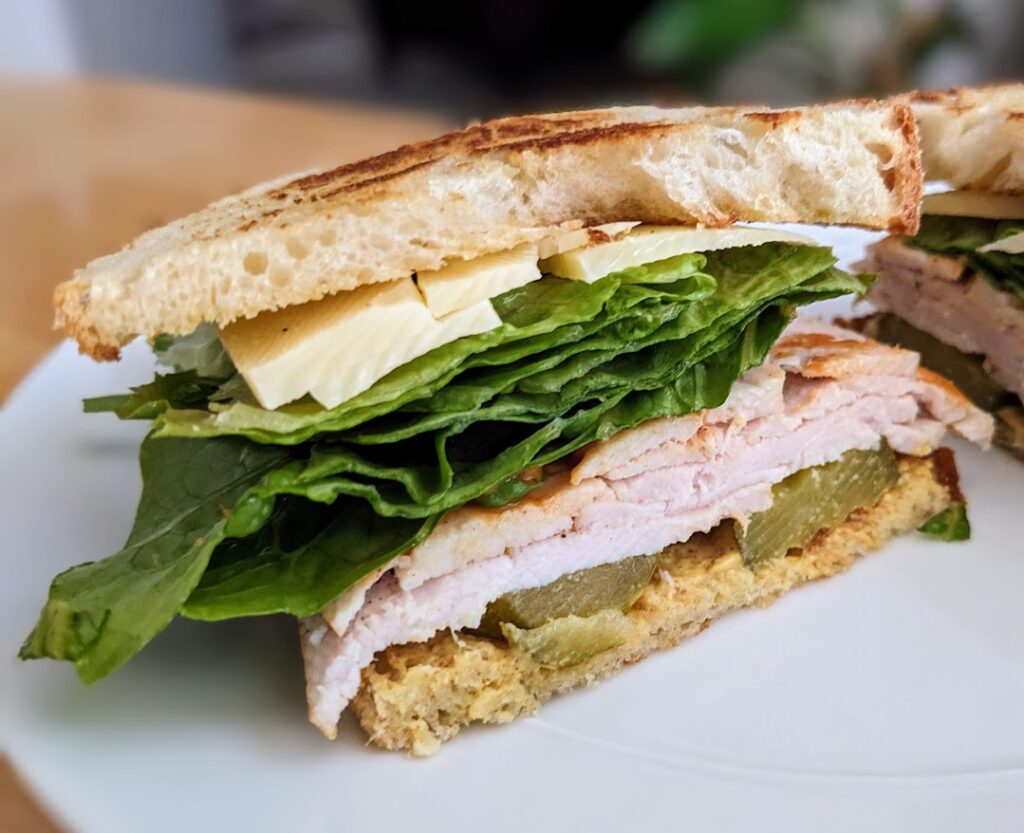 Half a toasted club sandwich made with Kirkland fully-cooked Turkey Breast from Costco.