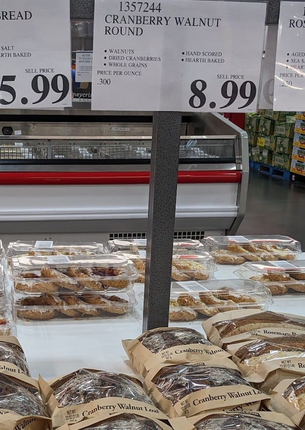 A Costco Bakery store display with loaves of Cranberry Walnut Bread.