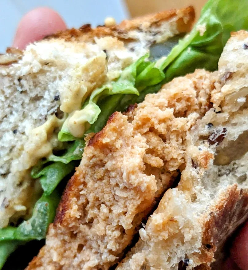 Detail of Aldi Fremont Chipotle Salmon Burger texture in a sandwich.