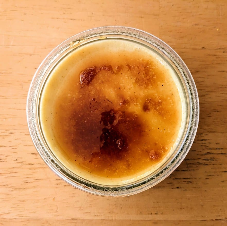 Caramelized sugar on top of a glass dish of Senoble French Creme Brulee from Costco.