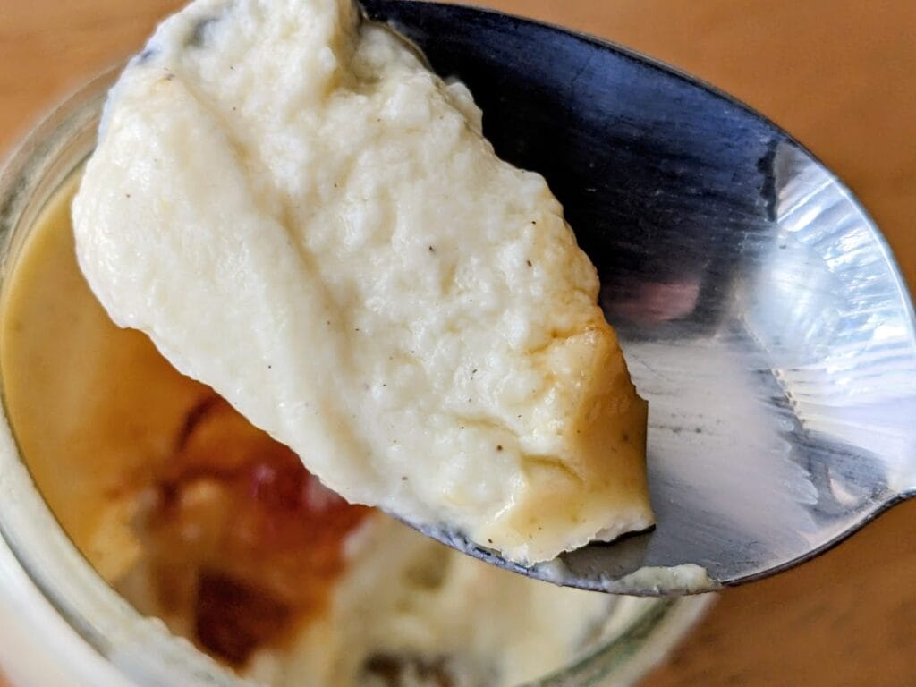 A spoon of vanilla bean flavored French Creme Brulee from Costco.