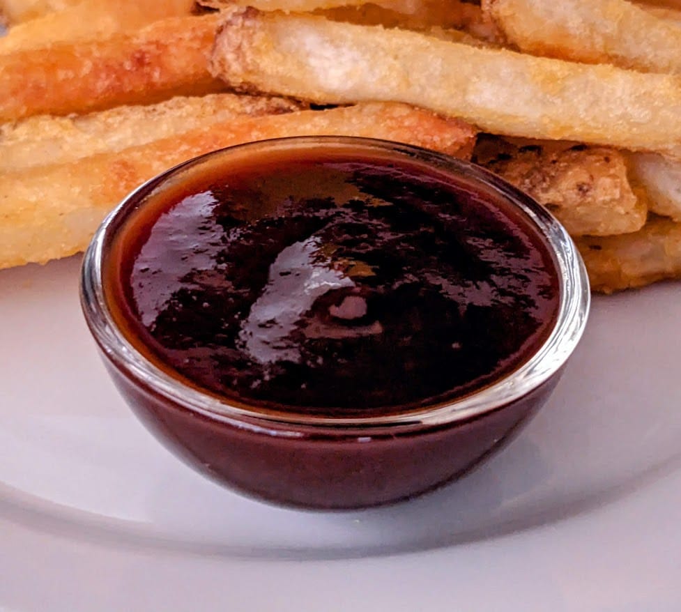 A small glass dish of Aldi Burman's Kansas City Style BBQ Sauce.