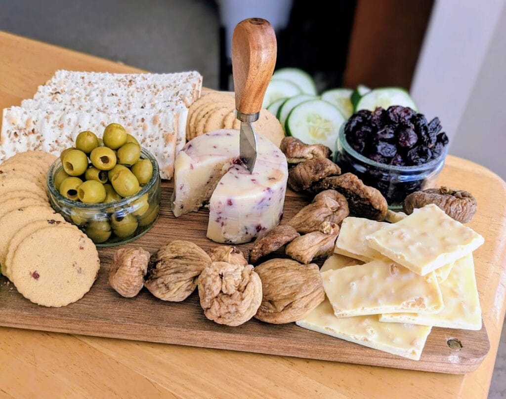 A charcuterie grazing board with Aldi Cranberry White Cheddar cheese.