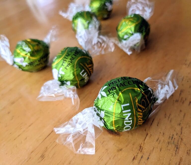 Several green wrapped Pistachio Truffles from Lindt Lindor candies.