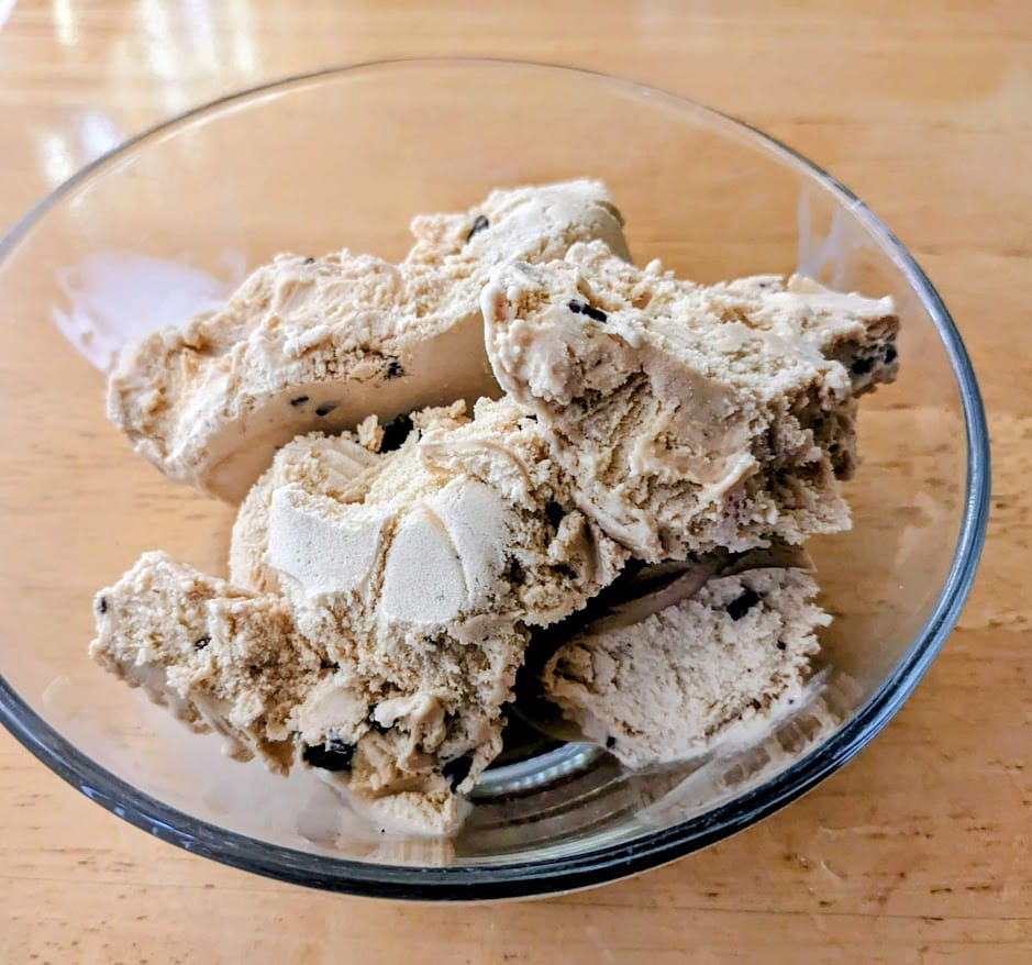 A glass bowl with scoops of Santa's White Christmas Ice Cream from Publix.