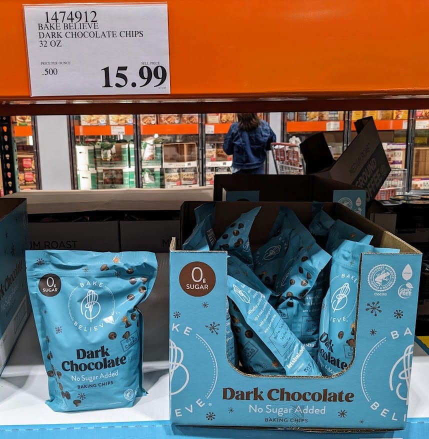 Blue bags of Bake Believe sugar free Dark Chocolate Chips inside a Costco warehouse.