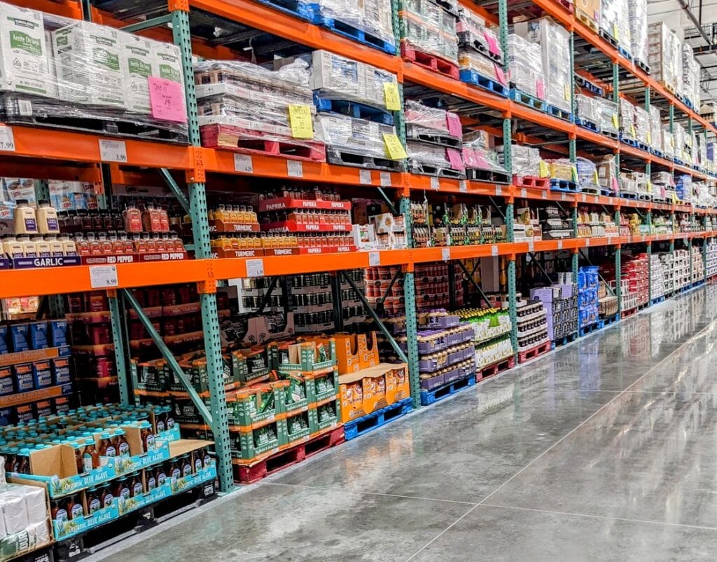 A dry good aisle at Costco with shelves of products.