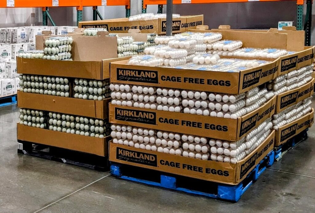 A large display of wholesale egg cartons inside a Costco warehouse.