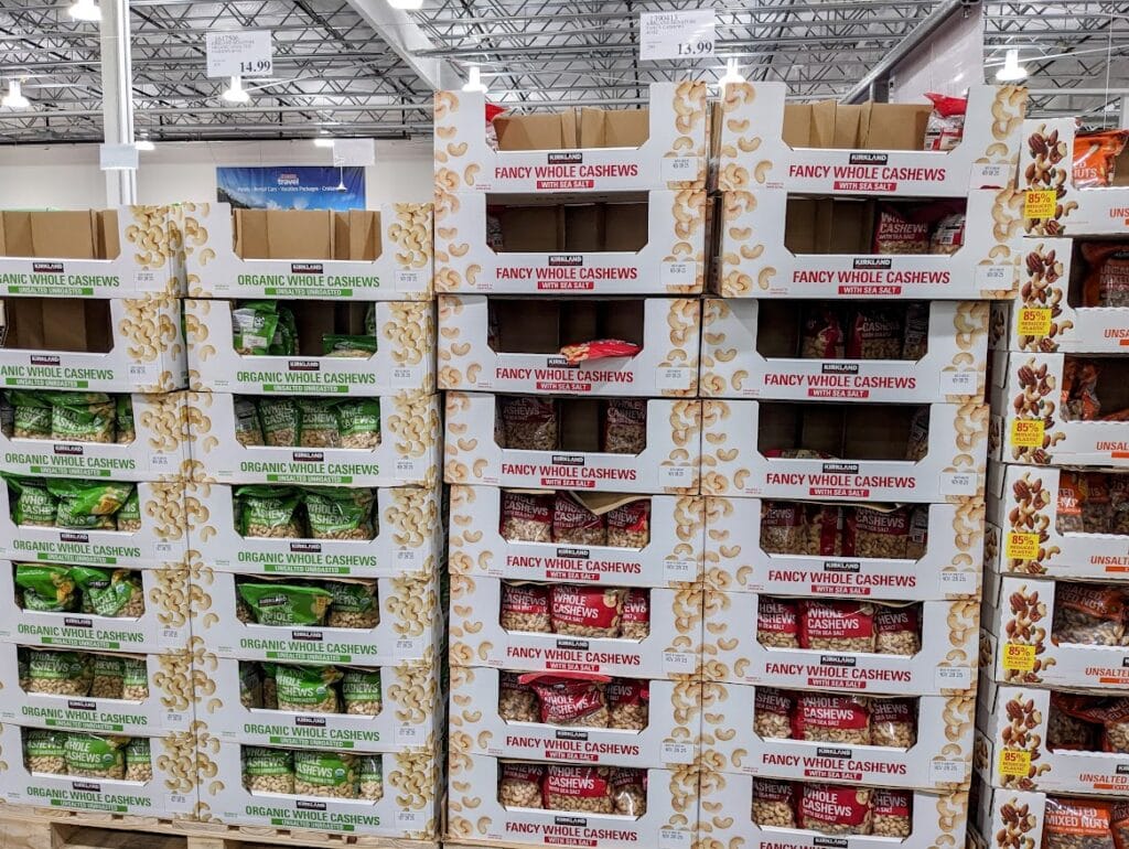 Stacks of bagged nuts in cardboard cartons inside a Costco store.