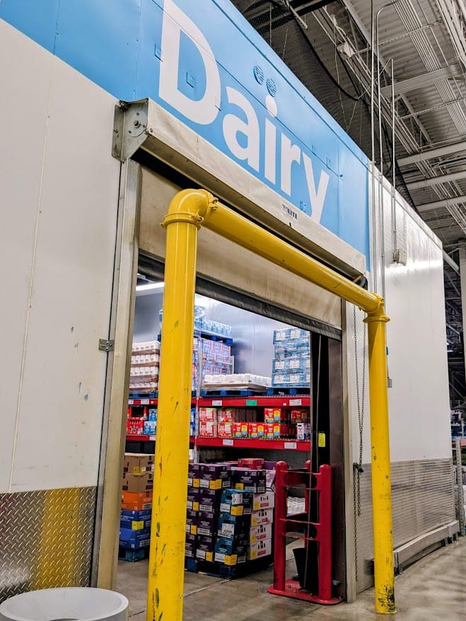 Entrance to the refrigerated Dairy section inside a Sam's Club warehouse.