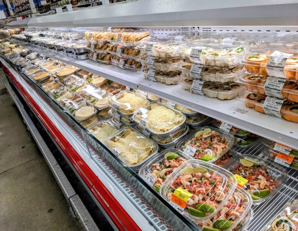Refrigerated case with prepared meals inside a Sam's Club Deli.