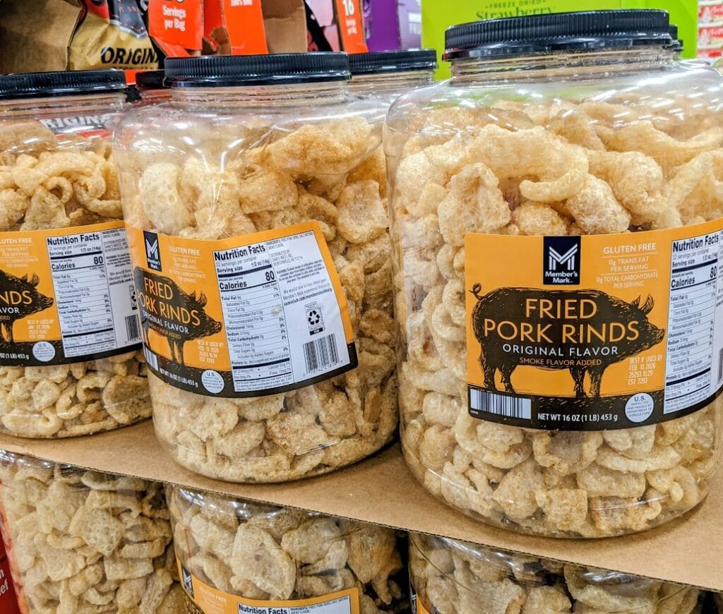 Plastic barrels of Member's Mark Fried Pork Rinds inside a Sam's Club warehouse.