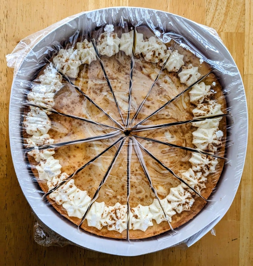 A shrink wrapped frozen Pumpkin Cheesecake from Sam's Club.