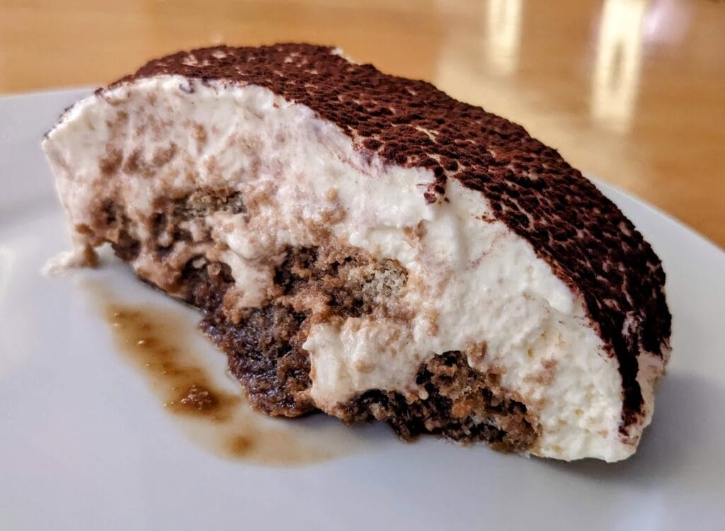 A slice of Sam's Club tiramisu on a white plate.