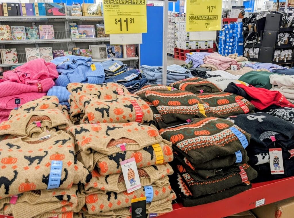 Stacks of folded Vince Camuto fall-themed sweaters inside a Sam's Club.