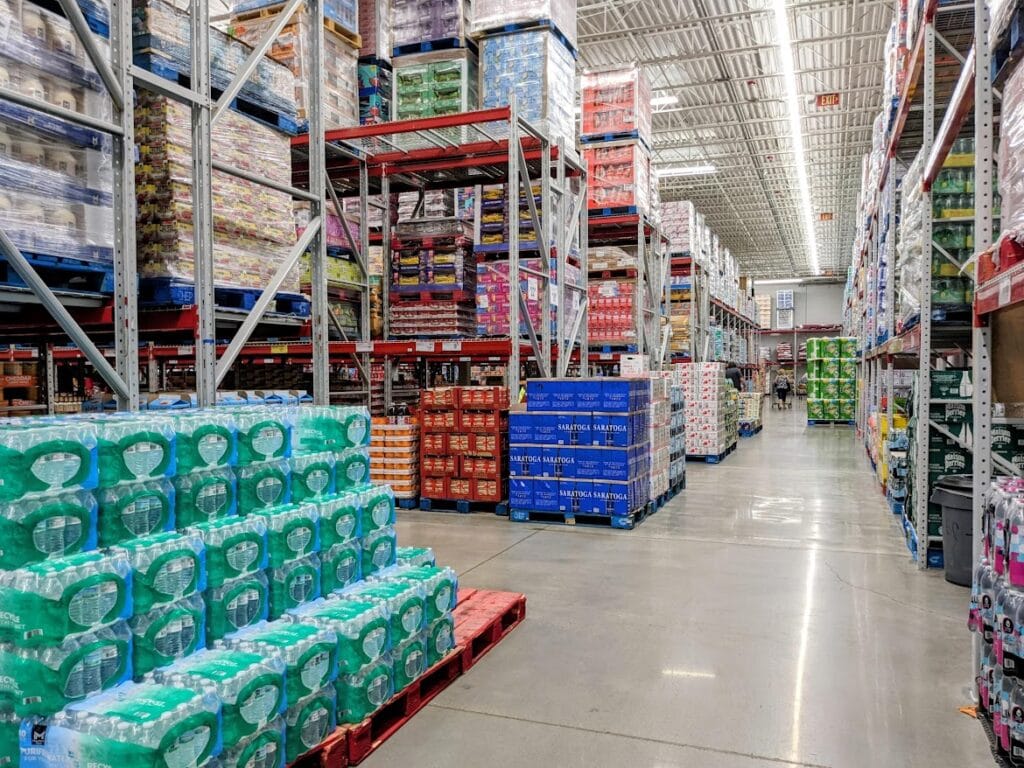 The interior of a Sam's Club warehouse with shelves and pallets of products.