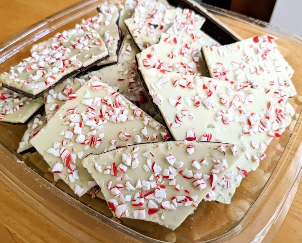 A box of Costco Kirkland Peppermint Bark sitting on a kitchen table.