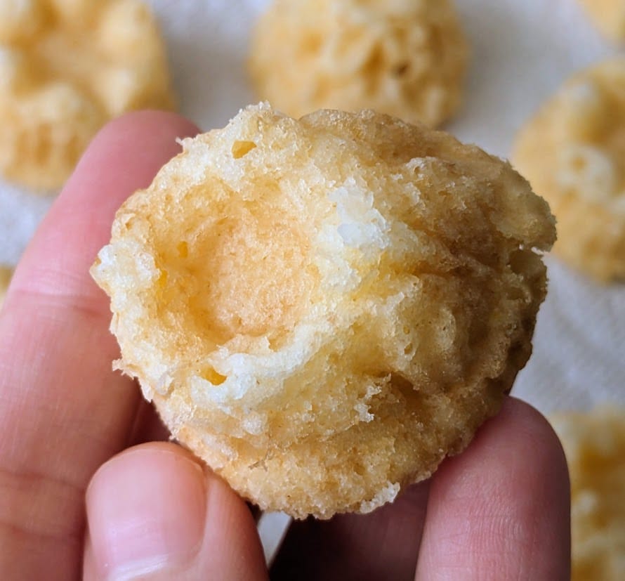 Fingers holding a mini bundtlet cakelet.