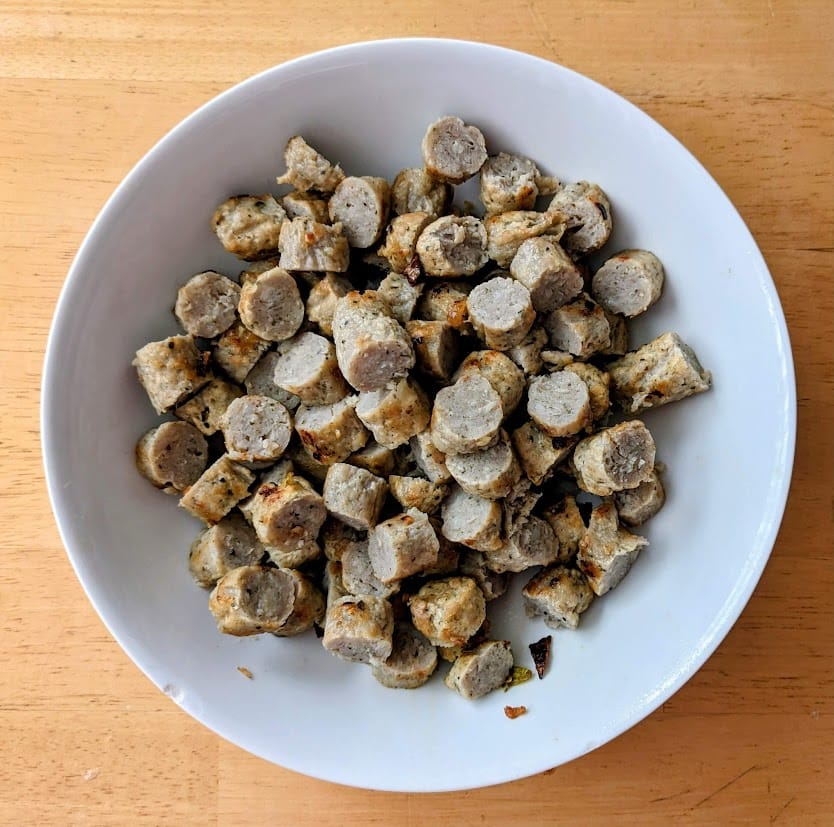 A white bowl of chopped Jones Organic Chicken Sausage.