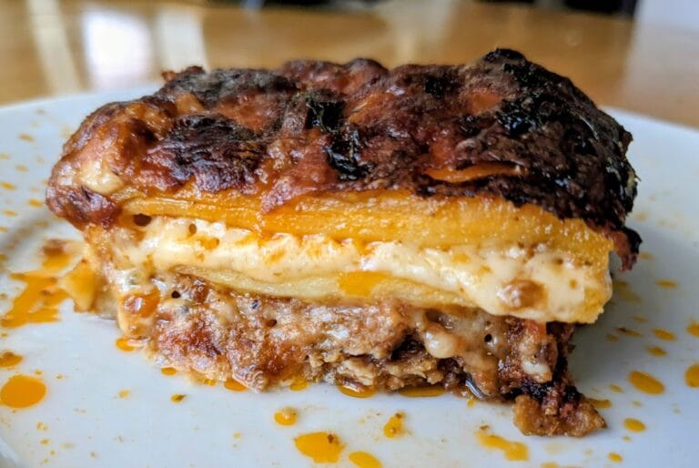 A slice of Costco Deli Ravioli Lasagna with Beef Pork Bolognese Sauce sitting on a plate.