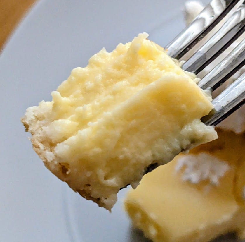 A fork with a bite of filling from a Lemon Custard Pie.