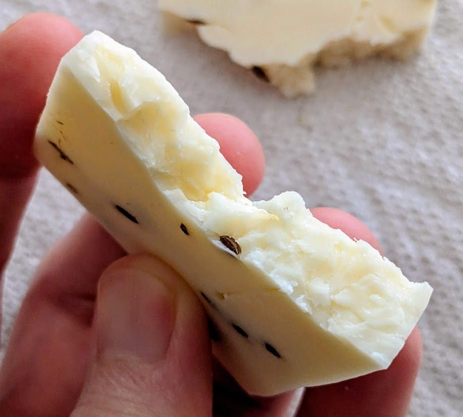 Curd texture in a slice of Caraway Cheddar Cheese from Meister.