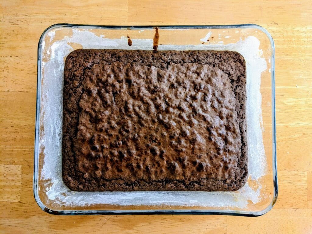 A glass pan with baked brownie mix from Aldi.