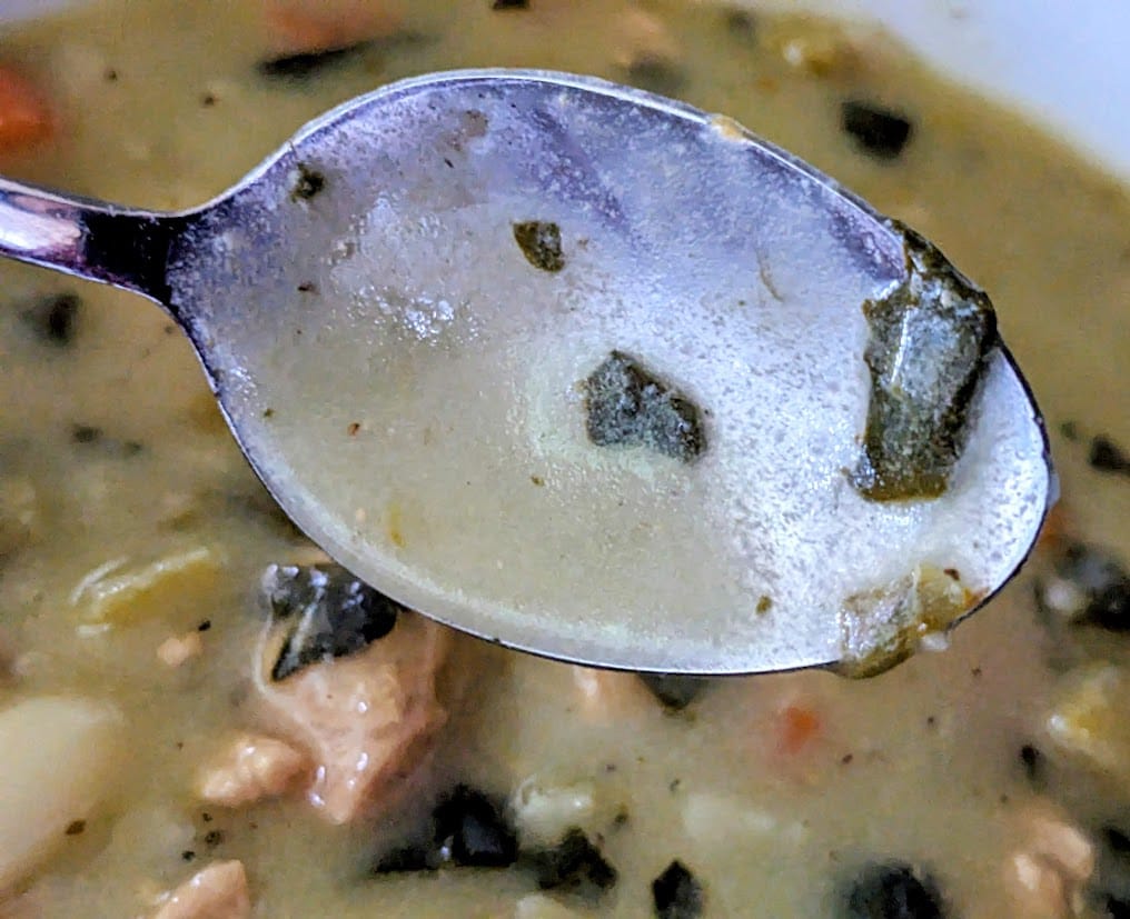 A spoon coated in the viscous broth of Rao's Chicken & Gnocchi Soup.