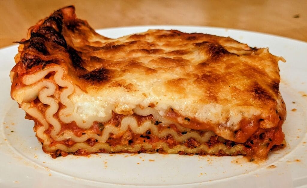 A slice of leftover Bremer Lasagna with Meat Sauce from Aldi sitting on a plate.