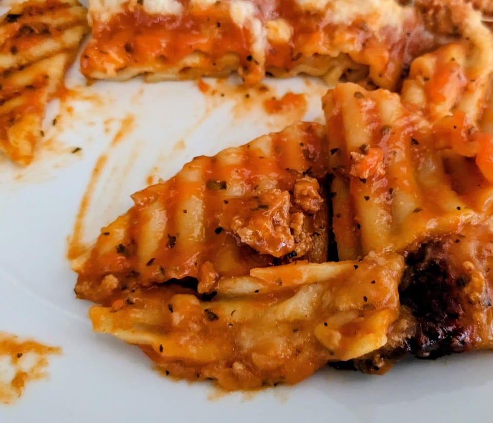 Close up of noodles and small piece of meat from a Bremer frozen Lasagna with Meat Sauce from Aldi.
