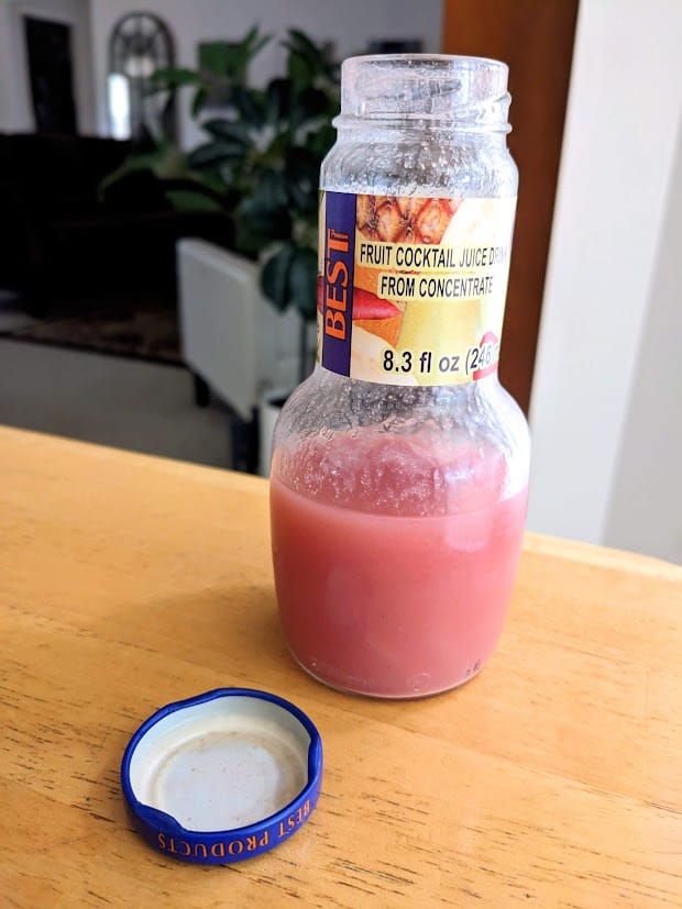 An open, half-consumed bottle of Fruit Cocktail Juice Drink from Egypt Canning Co ("BEST" brand).
