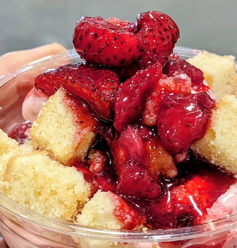Fruit and syrup on top of a Costco Strawberry Shortcake Sundae.