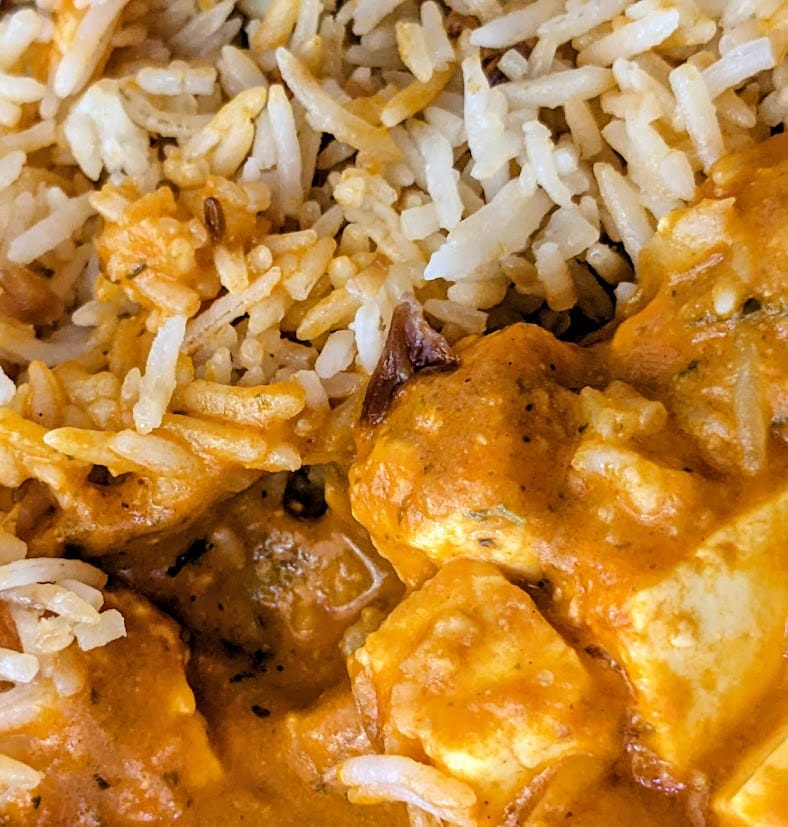 Paneer Tikka Masala next to Onion Basmati Rice from a Deep Indian frozen meal.