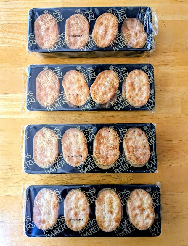 Four sealed trays of Karens Bakery Danish Puff Pastries from Costco sitting on a kitchen table.