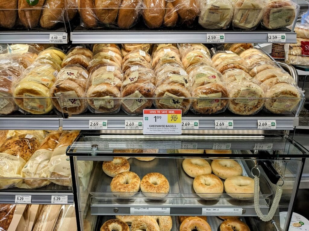 A display of bagels and baked goods inside a Publix grocery store.