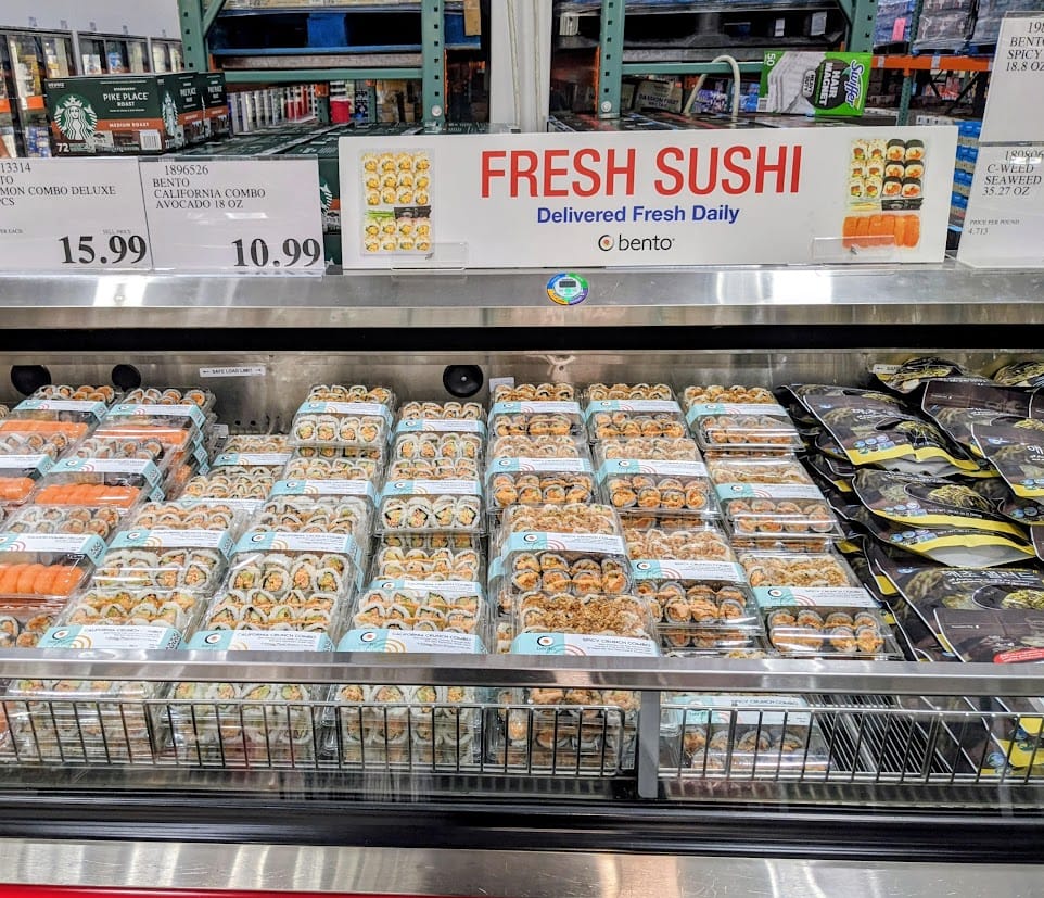 A display of pre-packaged Bento Sushi inside a Costco warehouse.