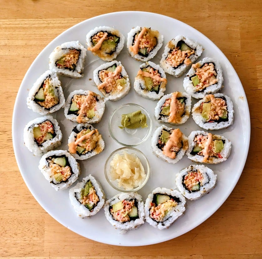 A white plate with an assortment of Costco sushi.