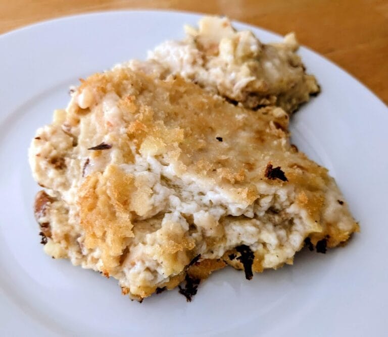 A white plate with a serving of Rana 4 Cheese Chicken Carbonara Lasagna.
