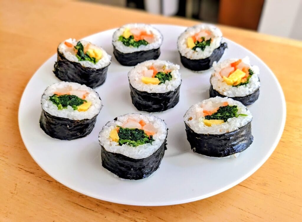 Pieces of Aldi Kimbap (Traditional flavor) on a white plate.