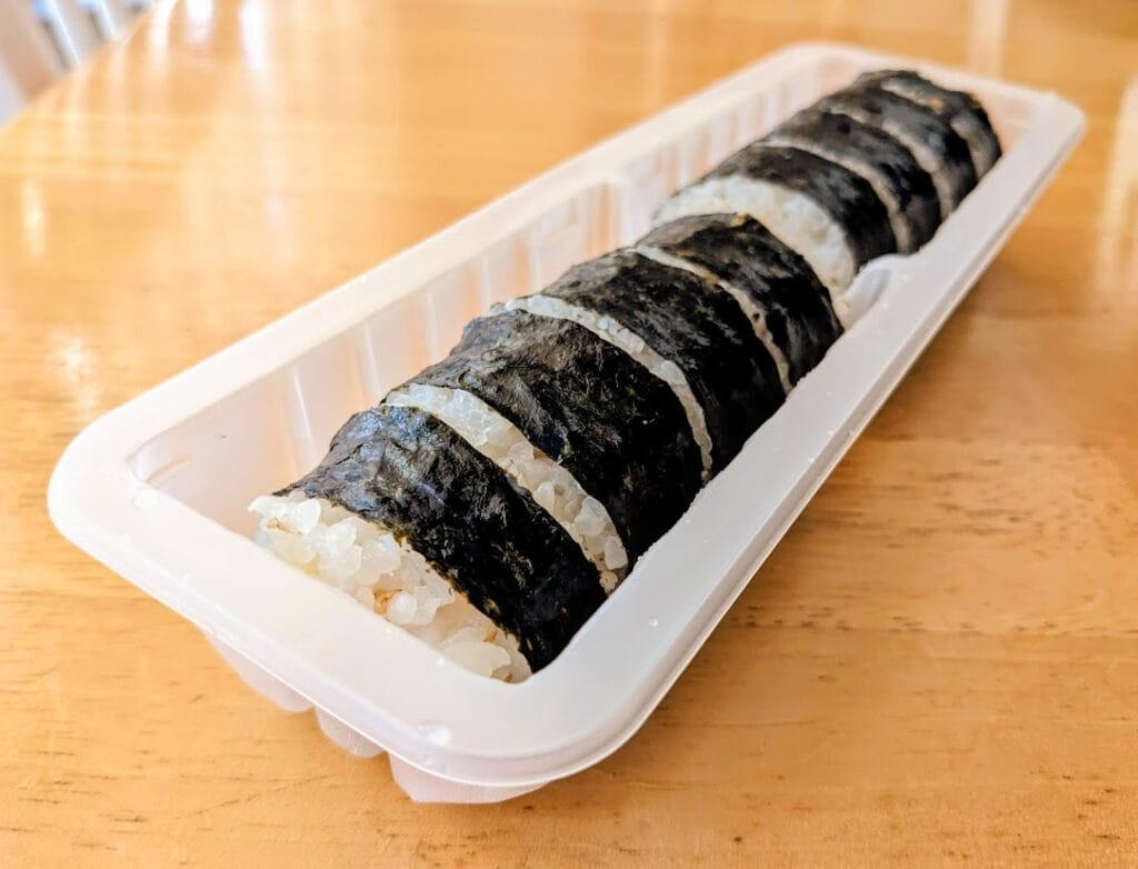 A plastic tray with pieces of Aldi frozen Kimbap, sitting on a kitchen table.
