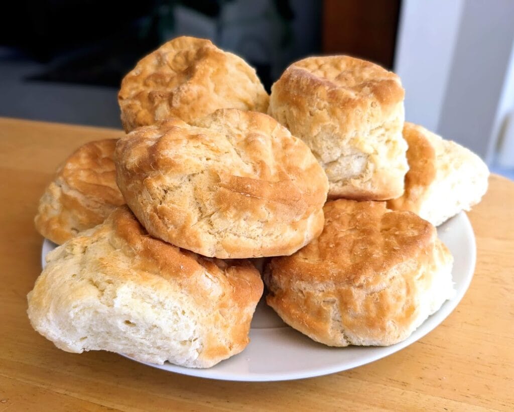 A plate with a pile of large Buttermilk Biscuits from Costco.