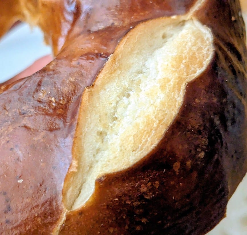 Detail of scored bread texture on a Costco Pretzel Bagel.