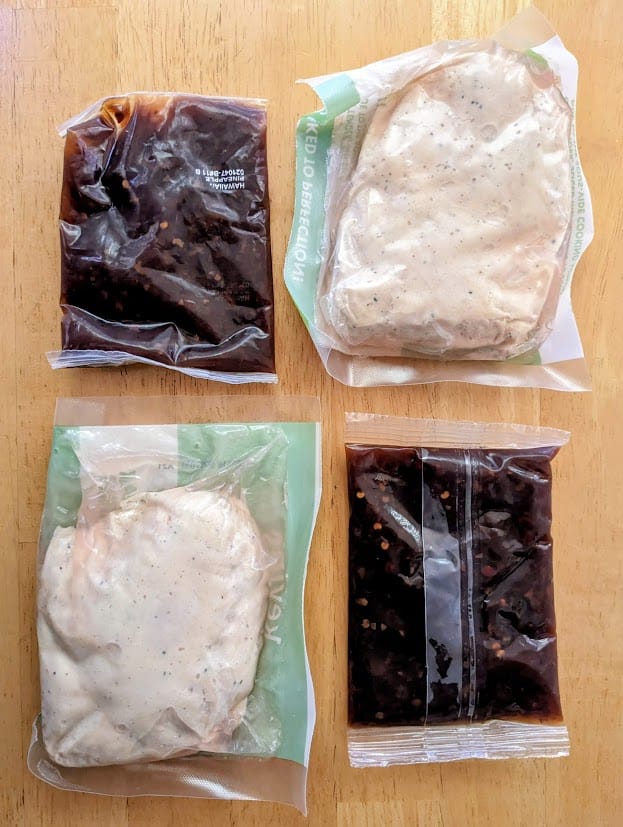 Pouches of sous vide chicken and sauce from a package of Hawaiian-Style Chicken from Kevin's Natural Foods.