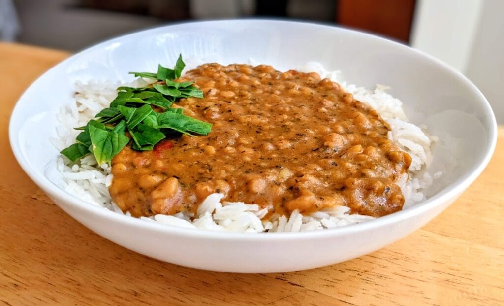 A white bowl of Maya Kaimal Indian Everyday Dal over basmati rice.