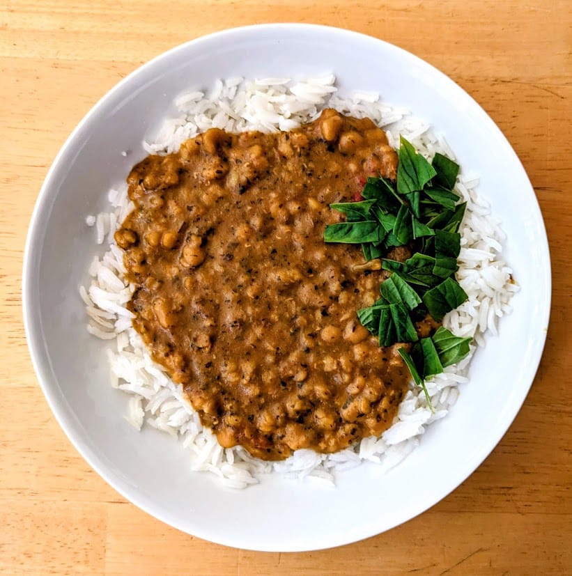 Overhead view of a bowl of basmati rice topped with Everyday Dal from Maya Kaimal.