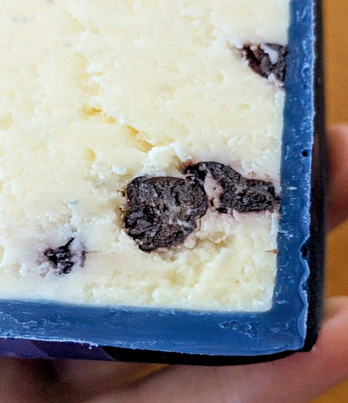 Close up of the blue wax coating around a piece of Somerdale Wensleydale & Blueberries imported British cheese.